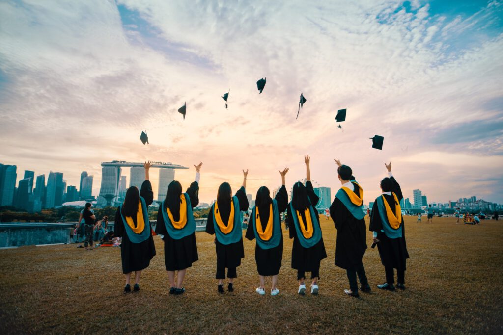 Seven College Students Throwing Graduation Caps